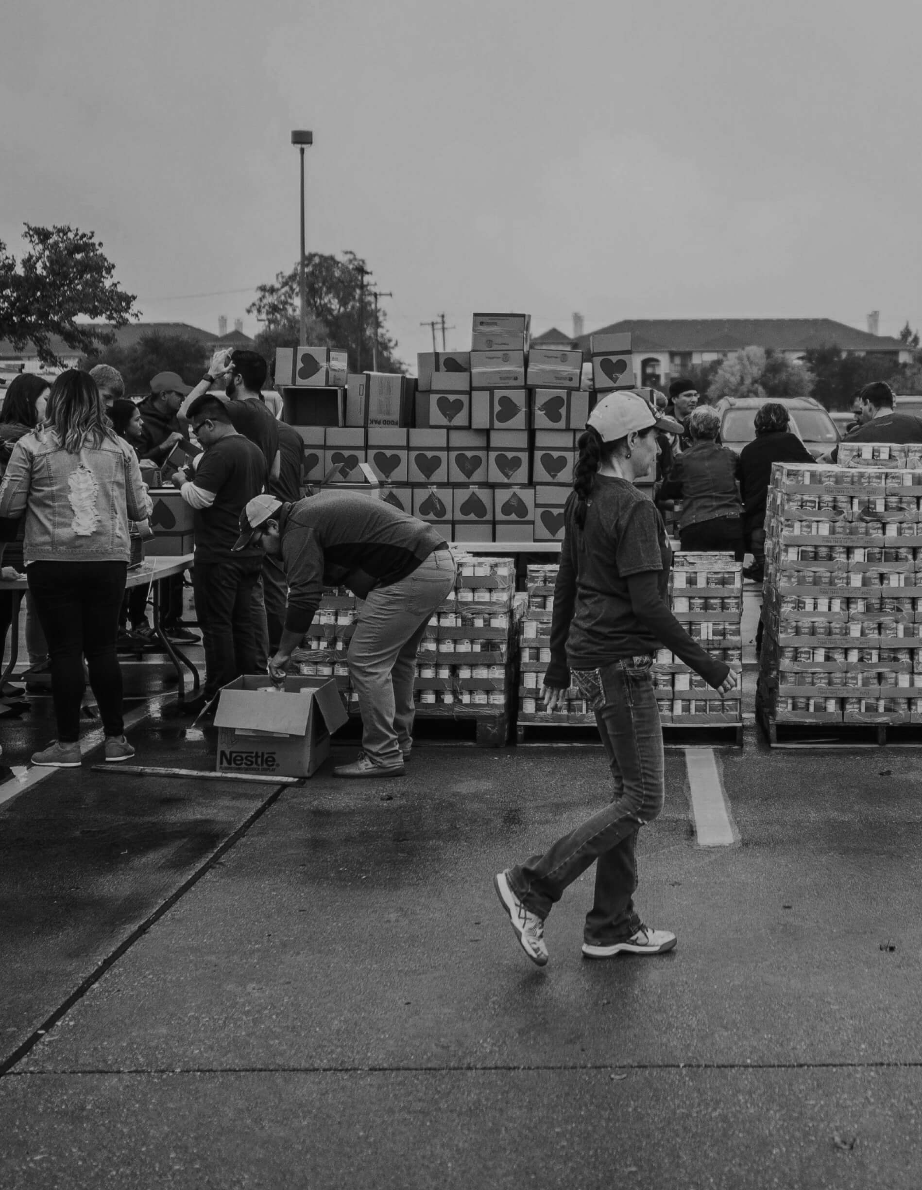 Who We Serve Non-Profit We serve nonprofit organizations in any community. A young woman is walking inside a parking lot with donation boxes.