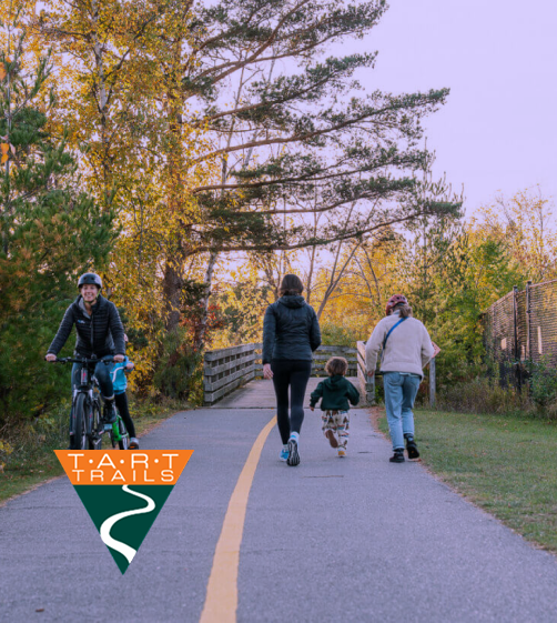 TART Trails in Traverse City, Michigan. A family walking and biking down the trail.